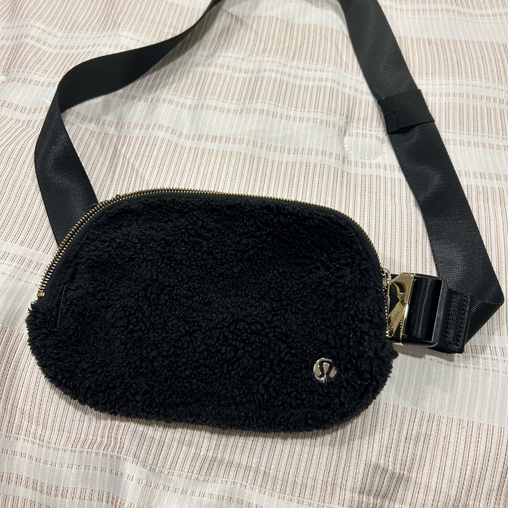 Fluffy black lululemon belt bag with gold hardware